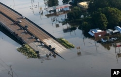 People launch boats from an overpass into floodwaters in the aftermath of Tropical Storm Harvey in Kountze, Texas, Aug. 31, 2017.