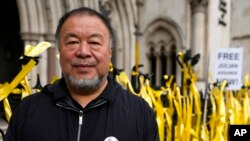 FILE - Chinese artist Ai Wei Wei joins supporters of Julian Assange as they stage a demonstration outside the High Court in London, Oct. 27, 2021.