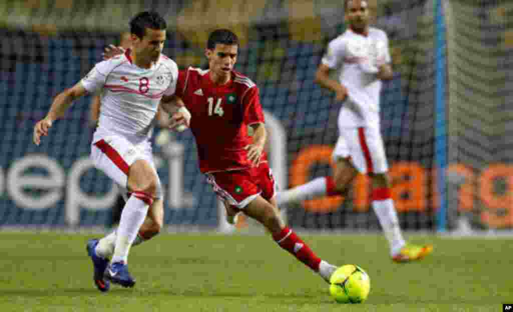 Morocco's Baussoufa Mbarak plays against Tunisia's Korbi Khaled during their African Cup of Nations Group C soccer match in Libreville