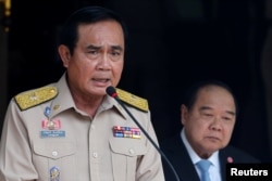 Thailand's Prime Minister Prayuth Chan-ocha speaks during a news conference after his meeting with National Security Council as Deputy Prime Minister and Defence Minister Prawit Wongsuwan looks on at Government House in Bangkok, Aug. 15, 2016.