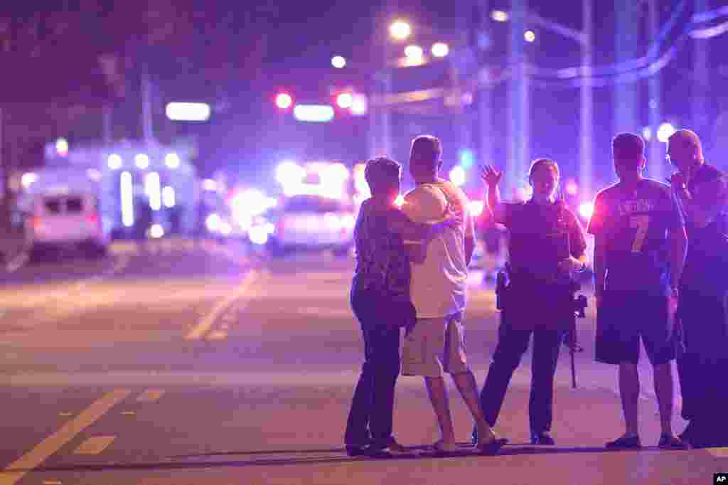 Orlando Police officers direct family members away from a multiple shooting at a nightclub in Orlando, Florida, June 12, 2016.