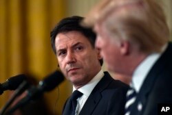 Italian Prime Minister Giuseppe Conte, left, listens as President Donald Trump, right, speaks during a news conference in the East Room of the White House in Washington, July 30, 2018.