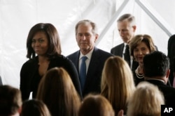 First lady Michelle Obama, from left, former President George W. Bush and Laura Bush leave the funeral service for former first lady Nancy Reagan at the Ronald Reagan Presidential Library in Simi Valley, California, March 11, 2016.