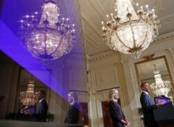 U.S. President Barack Obama and Dr. Jill Biden, wife of U.S. Vice President Joe Biden, are reflected in a monitor at the Community College Summit in the East Room at the White House in Washington, October 5, 2010. REUTERS/Jim Young
