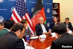 FILE - U.S. special envoy for peace in Afghanistan, Zalmay Khalilzad, center, speaks during a roundtable discussion with Afghan media at the U.S Embassy in Kabul, Afghanistan Jan. 28, 2019.
