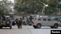 Afghan security forces arrive at the site of a blast in Kabul, Afghanistan, July 15, 2018.