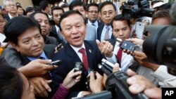 Cambodia's main opposition Cambodia National Rescue Party Acting President Kem Sokha, center, speaks to reporters outside the Phnom Penh Municipality Court in Phnom Penh, Cambodia, Wednesday, April 8, 2015. 