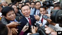 Cambodia's main opposition Cambodia National Rescue Party Deputy President, center, speaks to reporters outside the Phnom Penh Municipality Court in Phnom Penh, Cambodia, Wednesday, April 8, 2015. 