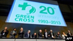 Participants applaud on September 2, 2013, in Geneva during the opening of a conference to celebrate the 20th anniversary of Green Cross International.
