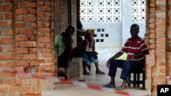 People suspected of having the Ebola virus wait at a treatment center in Bikoro, Democratic Republic of Congo, May 13, 2018. Congo's latest Ebola outbreak has spread to a city of more than 1 million people, a worrying shift.