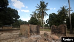 FILE - Burnt-out huts are seen at the scene of an armed attack in Chitolo village, Mozambique, July 10, 2018. 