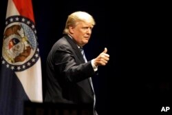 Republican presidential candidate Donald Trump acknowledges supporters’ applause at a campaign rally in St. Louis, Mo., March 11, 2016.