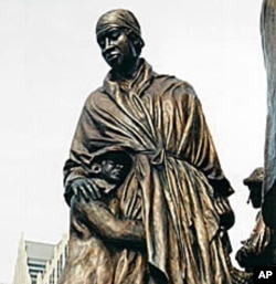 This detail from Dwight's memorial to the Underground Railroad depicts a mother comforting her child as they prepare to cross the Detroit River to freedom.