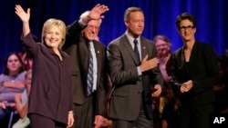 Democratic presidential candidates, from left, Hillary Clinton, Sen. Bernie Sanders and former Maryland Governor Martin O'Malley participate in a candidate forum hosted by MSNBC's Rachel Maddow, right, at Winthrop University in Rock Hill, S.C., Nov. 6, 20