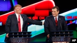 Donald Trump, left, jokes with Ted Cruz during the CNN Republican presidential debate at the Venetian Hotel & Casino on Tuesday, Dec. 15, 2015.