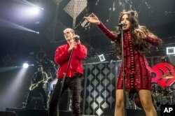 Machine Gun Kelly, left, and Camila Cabello perform at Y100's iHeartRadio Jingle Ball 2016 at BB&T Center in Sunrise, Florida.