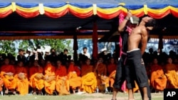 Cambodian students re-enact torture executed by the Khmer Rouge to mark the annual "Day of Anger" at Choeung Ek, 20 May 2010