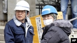 Workers transport products at Sony's tsunami-crippled warehouse near Sendai port, March 23, 2011
