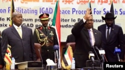 Sudan's President Omar Al-Bashir flanked by Uganda's President Yoweri Museveni and South Sudan's President Salva Kiir welcomes delegates during a South Sudan peace meeting as part of talks to negotiate an end to a civil war, in Khartoum, Sudan, June 25, 2018.