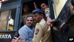 One of the men accused in the 2006 Mumbai train bombings is escorted by policemen from a prison to a court in Mumbai, India, Wednesday, Sept. 30, 2015. 