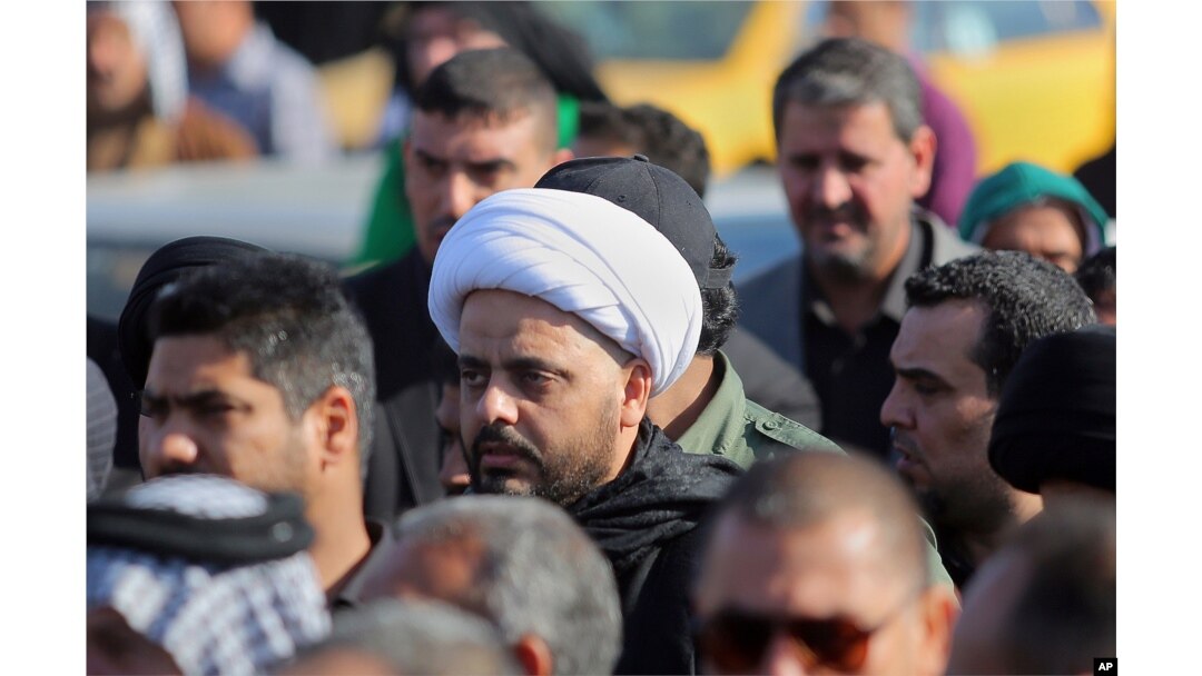 FILE - Qais al-Khazali, center, the leader of the Shi'ite group Asa'ib Ahl al-Haq, or League of the Righteous, attends a funeral procession of six members of his militia who were killed in Tikrit fighting Islamic militants.