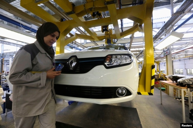 FILE - A female employee works in a Renault factory in Oran, west of Algiers, Nov. 10, 2014.
