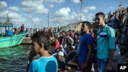 Arhiva - Egipatski migranti na obali čekaju na brod koji donosi tela migranata stradalih kada je potonulo njihovo plovilo kojim su, preko Sredozemnog mora, pokušali da se domognu evropske opbale, Rozeta, Egipat, 22. septembar 2016. (AP Photo/Eman Helal)