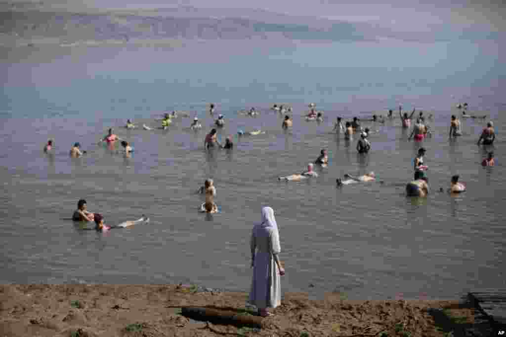 Tourists float in the Dead Sea, Israel.
