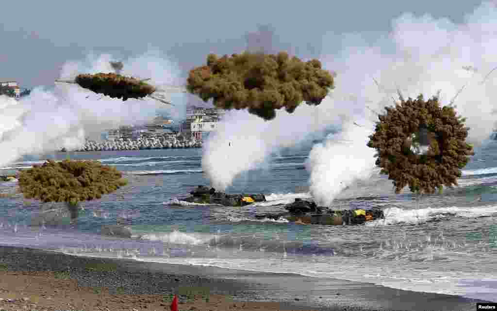 Amphibious assault vehicles of the South Korean Marine Corps throw smoke bombs as they move to land on shore during a U.S.-South Korea joint landing operation drill in Pohang.