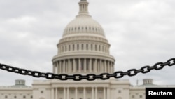 The dome of the U.S. Capitol is seen beyond a chain fence during the partial government shutdown in Washington, Jan. 8, 2019. 