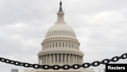 The dome of the U.S. Capitol is seen beyond a chain fence during the partial government shutdown in Washington, Jan. 8, 2019. 