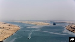FILE - This Aug. 6, 2015 file photo shows the entrance of the new section of the Suez Canal in Ismailia, Egypt. The Suez Canal, which connects the Red Sea to the Mediterranean Sea, is also a path for species to enter the Mediterranean Sea.