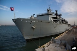 FILE - The British Royal Navy amphibious assault ship HMS Bulwark anchored in Haifa port, Israel.