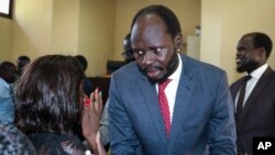 South Sudanese activist and economist Peter Biar Ajak talks to his wife Nyathon Hoth Mai after he was sentenced to two years in prison, in Juba, South Sudan, June 11, 2019. 