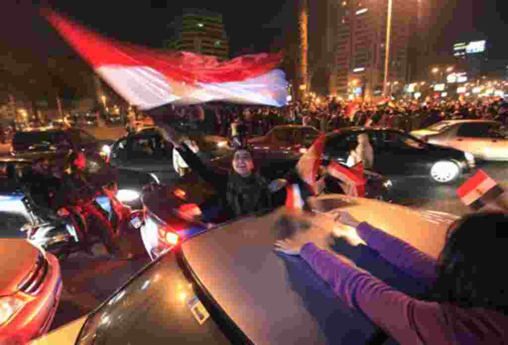 Egyptians celebrate after President Hosni Mubarak resigned and handed power to the military in Cairo, Egypt, Friday, Feb. 11, 2011. Egypt exploded with joy, tears, and relief after pro-democracy protesters brought down President Hosni Mubarak with a momen