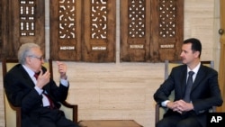 In this photo released by the Syrian official news agency SANA, Syrian President Bashar al-Assad, right, meets with UN Arab League deputy to Syria, Lakhdar Brahimi in Damascus, Syria, Dec. 24, 2012.