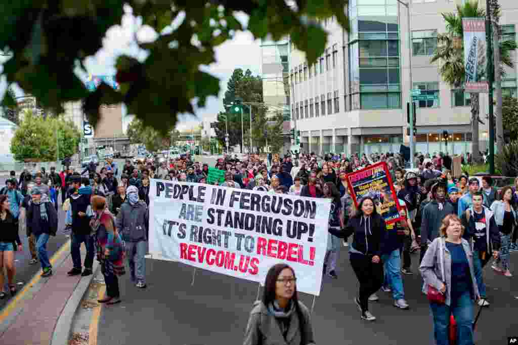 Several hundred demonstrators march through Oakland, California during a protest against the shooting of Michael Brown, Aug. 20, 2014.