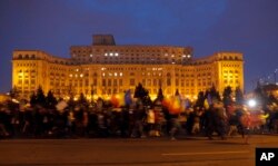 Demonstrators march in front of the government building during a protest in Bucharest, Romania, Feb. 4, 2017. On Saturday, thousands of Romanians took to the streets for a fifth consecutive day to protest a decree that waters down the country's anti-corru