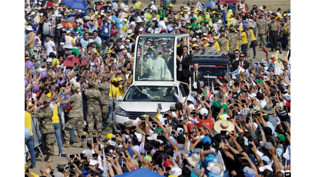 Pope Francis waves from his pope mobile as arrives to celebrate Mass on Huanchaco Beach, near the city of Trujillo, Peru, Jan. 20, 2018.