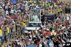 Pope Francis waves from his pope mobile as arrives to celebrate Mass on Huanchaco Beach, near the city of Trujillo, Peru, Jan. 20, 2018.