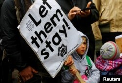 FILE - Protesters take part in a demonstration against racism and European asylum policy in Vienna, Austria, March 18, 2017.