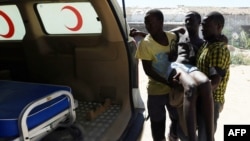 An illegal migrant is carried to an ambulance after he was rescued by the Libyan coast guard when the boat he was on sank off the coastal town of Garabulli, 60 kilometers east of Tripoli, Sept. 15, 2014. 