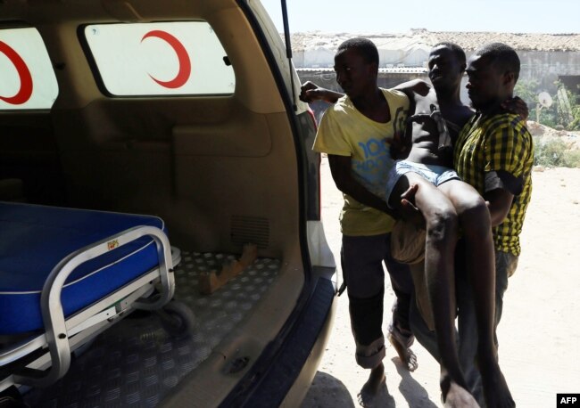 FILE - An illegal migrant is carried to an ambulance after he was rescued by the Libyan coast guard when the boat he was on sank off the coastal town of Garabulli, 60 kilometers east of Tripoli, Sept. 15, 2014.