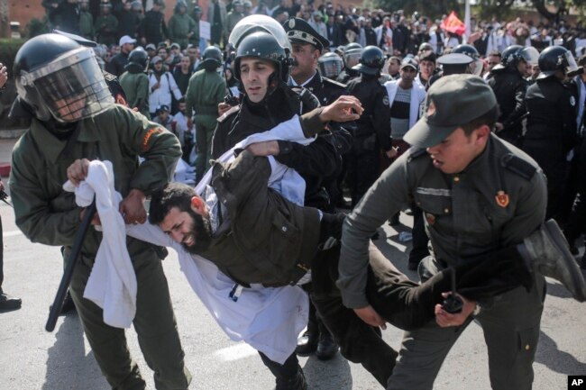 Security forces detain a protesting teacher during a demonstration in Rabat, Morocco, Feb. 20, 2019.