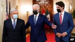 FILE - President Joe Biden walks with Mexican President Andrés Manuel López Obrador and Canadian Prime Minister Justin Trudeau during a meeting in the East Room of the White House in Washington, Nov. 18, 2021.