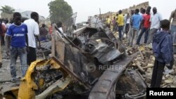 People look at damage in a market area after a bomb explosion in Borno State, Nigeria. (March 2, 2014.)