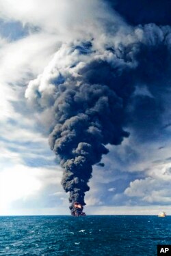 In this photo provided by China's Ministry of Transport, smoke and flames rise from the burning Iranian oil tanker Sanchi in the East China Sea off the eastern coast of China, Jan. 14, 2018.