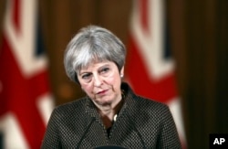 Britain's Prime Minister Theresa May listens during a press conference in 10 Downing Street, London, April 14, 2018.