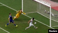 Iran's Reza Ghoochannejhad, right, scores against Bosnia during their match at the Fonte Nova arena in Salvador, June 25, 2014.