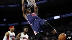 Washington Wizards center Ian Mahinmi dunks during second half of an NBA basketball game against the Detroit Pistons.